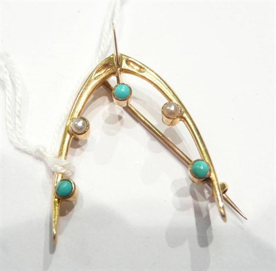 Lot 239 - A turquoise and seed pearl set wishbone brooch