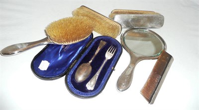 Lot 241 - A cased christening fork and spoon, a mirror, four brushes and a comb