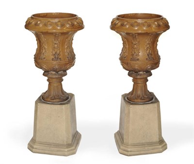 Lot 1304 - A Pair of Victorian Brown Glazed Earthenware Pedestal Campana Urns, circa 1880, with gadrooned...