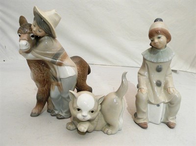 Lot 297 - Lladro group of a young boy and donkey, Lladro figure of a clown and a similar Spanish figure...