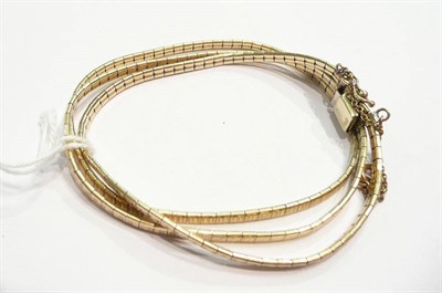 Lot 331 - A triple row bracelet stamped "585"