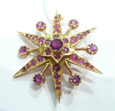 Lot 340 - 9ct star brooch with red stones