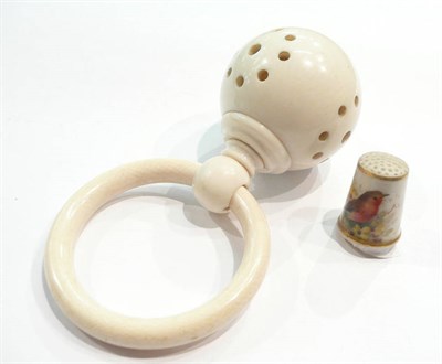 Lot 352 - A Royal Worcester china thimble painted with a robin and an ivorine child's rattle/teething ring