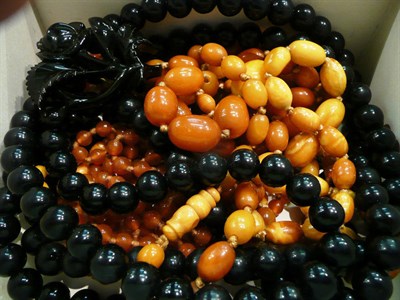 Lot 355 - A jet brooch and bead necklace, two amber bead necklaces and a glass necklace