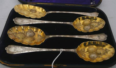 Lot 386 - A set of four silver gilt berry spoons