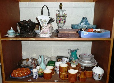 Lot 402 - Two shelves including a dog head tobacco jar, pottery table lamp, decorative ceramics, Lido...