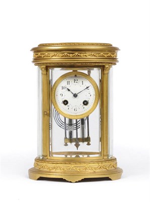 Lot 1323 - An Oval Four Glass Gilt Metal Striking Mantel Clock, circa 1900, the oval shaped case with...