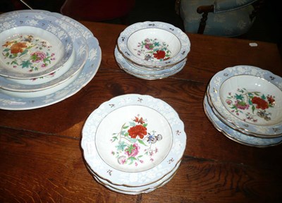 Lot 486 - 19th century pottery dinner service with pale blue border and floral decoration