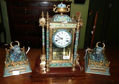 Lot 493 - Cloisonne mantel clock with an associated pair of modern cloisonne seated oxen on stands (3)