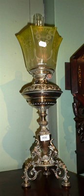 Lot 498 - Brass oil lamp on tripod base and yellow glass shade