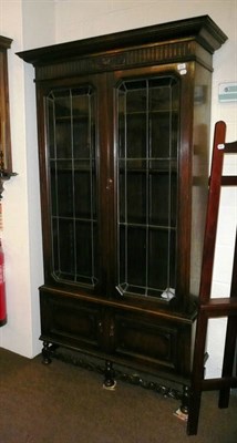 Lot 583 - Oak bookcase with leaded glazed doors