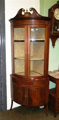 Lot 596 - Edwardian mahogany inlaid bow-front standing corner cabinet with swan neck pediment