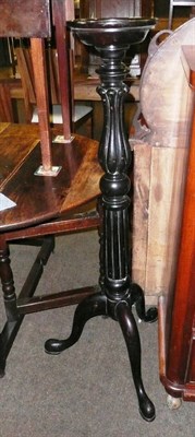 Lot 604 - Ebonised torchere on tripod base