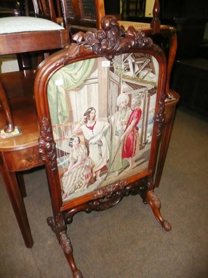 Lot 612 - Victorian rosewood carved fire-screen with embroidered panel