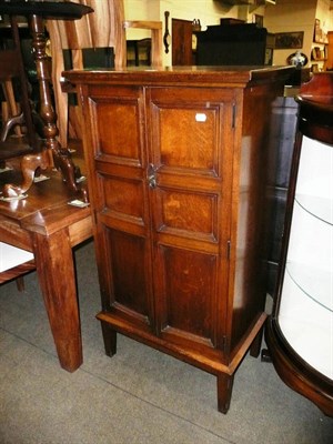 Lot 615 - Reproduction oak panelled two door cupboard