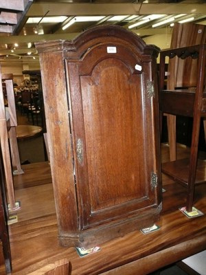 Lot 619 - A Georgian oak corner cupboard