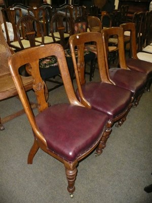 Lot 648 - A set of four carved oak dining chairs with leatherette seats