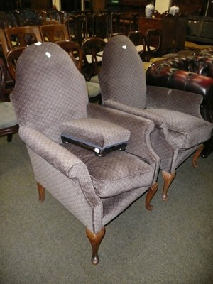 Lot 650 - Two velvet upholstered armchairs and a matching footstool (3)