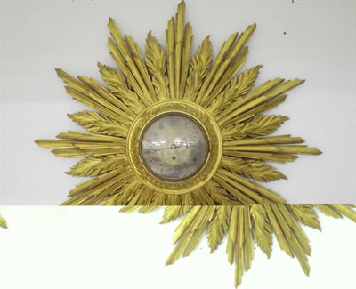 Lot 1342 - A Gilt Wood Sunburst Wall Timepiece, circa 1900, the case with multiple rays and flames...