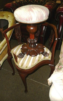 Lot 653 - Mahogany revolving piano stool and a corner armchair