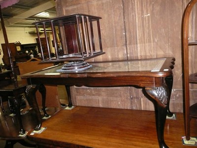 Lot 693 - Carved oak coffee table with petit point inserts and a table top revolving book shelf