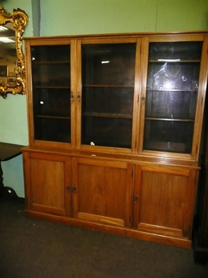 Lot 710 - Glazed oak three section bookcase (with key)