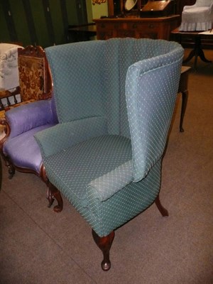 Lot 665A - An early 20th century upholstered wing armchair