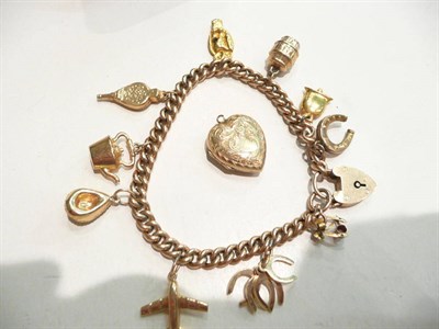 Lot 59 - Charm bracelet with 9 carat gold padlock fastener and hung with ten various charms and a heart...