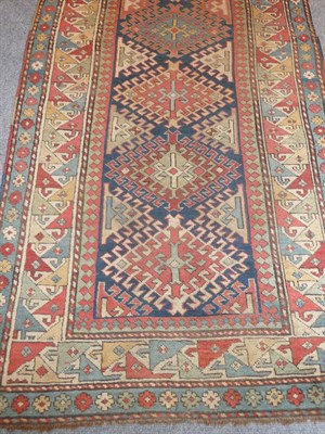 Lot 1375 - A Shirvan Runner, the field with a vertical row of seven hooked diamond medallions on an indigo...