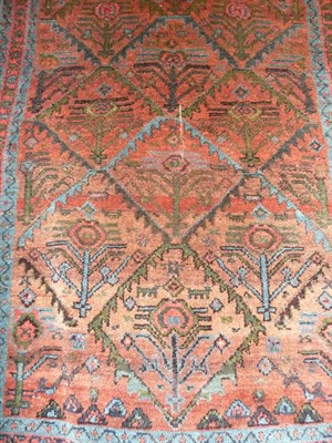 Lot 1376 - A Small Kurdish Rug, the rust brown field overlaid with a blue lattice, within blue an dark red...