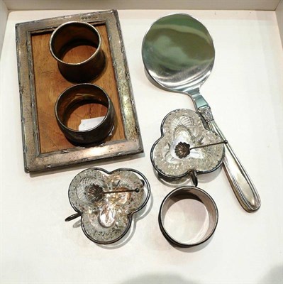 Lot 170 - A pair of cut glass salts with plated stands and silver spoons, three silver napkin rings, a silver