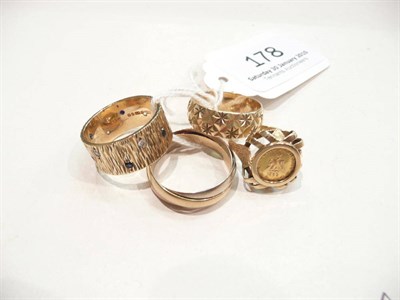Lot 178 - A 9 carat gold three colour Russian wedding ring, a 9 carat gold patterned band ring, a 9 carat...