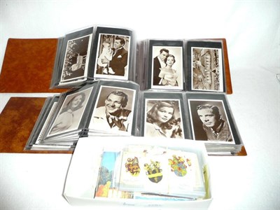 Lot 226 - A collection of postcards of film stars, in two albums, and a box of cigarette and trade cards