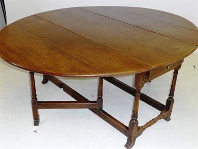 Lot 1389 - An Early 18th Century Oak Gateleg Dining Table, the oval top over a drawer to each end, on...