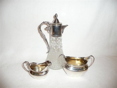 Lot 244 - Silver plated claret jug and a silver cream and sugar