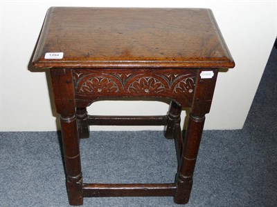 Lot 1394 - A 17th Century Oak Joined Stool, the moulded top on deep lunette-carved rails and pillar legs...