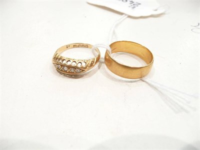 Lot 303 - A 22 carat gold wedding band 4.5g approximately and an 18 carat gold diamond five stone ring