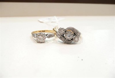 Lot 304 - A diamond solitaire ring with stone set shoulders and a diamond three stone twist ring with...