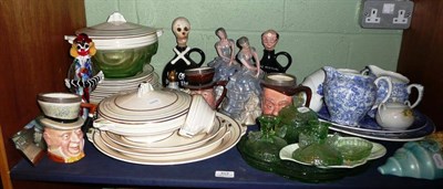 Lot 312 - A shelf including dinner ware, character jugs, blue and white jugs, green glass dressing table...