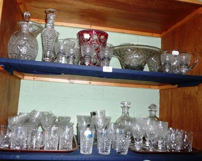 Lot 315 - Two shelves of assorted cut glassware including decanters, drinking glasses, vases, candlestick etc