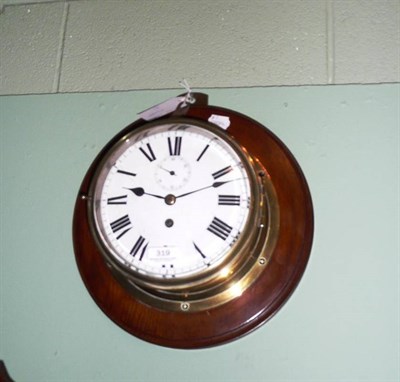 Lot 319 - Brass ships clock, later enamel dial, mounted on an oak back board