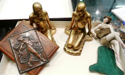 Lot 373 - A pair of gilt nude bookends, an Edwardian bisque reclining doll and an embossed plaque (4)