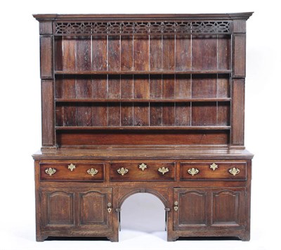 Lot 1404 - A George III Oak and Mahogany Crossbanded Dresser and Rack, the projecting moulded cornice...