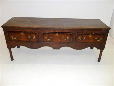 Lot 1405 - A George III Oak and Mahogany Crossbanded Low Dresser, the rectangular top with moulded edge...