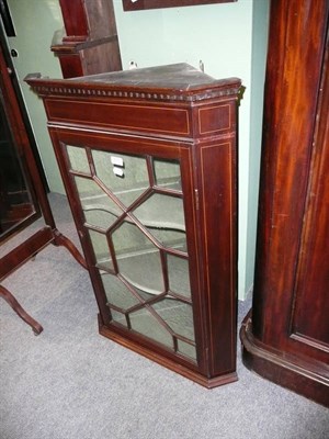 Lot 473 - A mahogany corner cupboard enclosed by an astragal glazed door