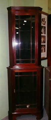 Lot 475 - An Edwardian mahogany glazed floor-standing corner cupboard