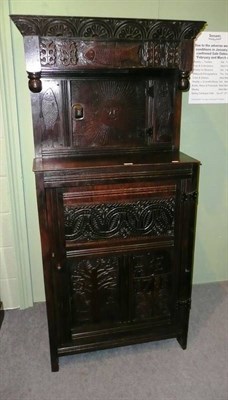 Lot 477 - Carved dark oak cupboard