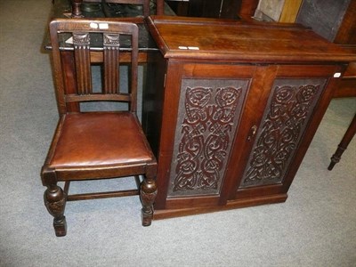 Lot 478 - Carved two door cupboard and a pair of oak dining chairs