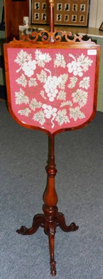 Lot 1414 - A Victorian Rosewood Pole Screen, the shield shaped frame containing a beadwork panel depicting...