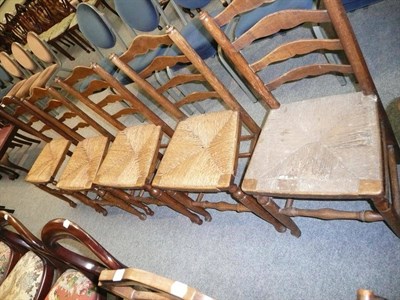 Lot 523 - Five rush-seated ladder-back chairs